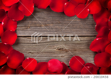Red rose petals over wooden table Red rose petals over wooden table 20010438