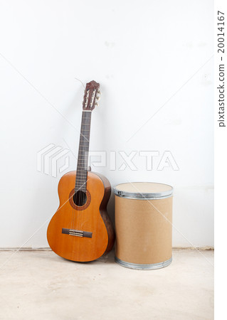 Old classical acoustic guitar on white wall background 20014167