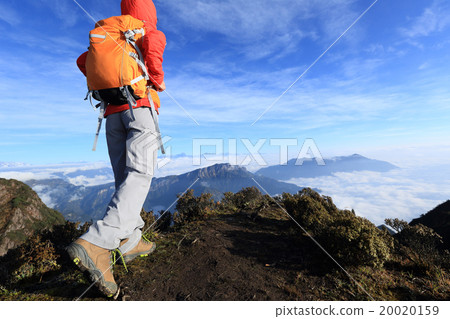 young woman backpacker hiking on mountain peak 20020159