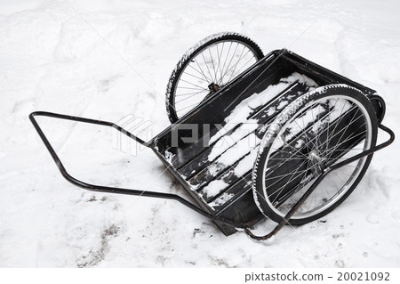 Black goods trolley stands on white snow 20021092