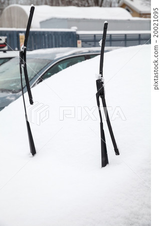 Car wipers lifted up over car covered with snow Car wipers lifted up over car covered with snow 20021095