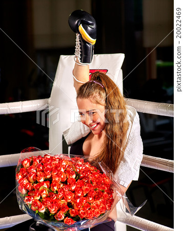 Girl wearing red gloves sitting in corner of Girl wearing red gloves sitting in corner of 20022469