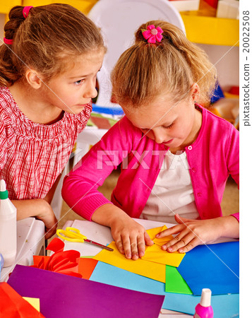 Kids holding colored paper on table in Kids holding colored paper on table in 20022508