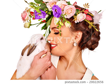 Woman in easter style holding eggs and flowers. Woman in easter style holding eggs and flowers. 20022656