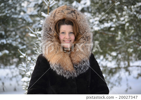 Positive middle-aged woman in fur coat at winter Positive middle-aged woman in fur coat at winter 20027347