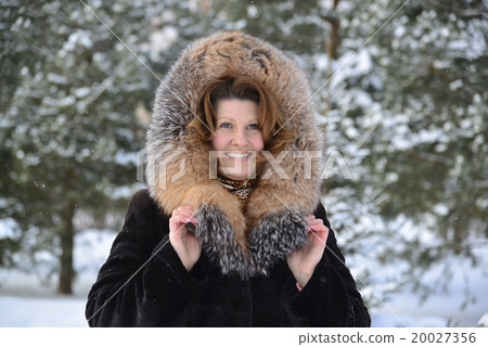 Positive middle-aged woman in fur coat at winter Positive middle-aged woman in fur coat at winter 20027356