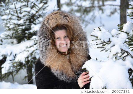 Positive middle-aged woman in fur coat at winter Positive middle-aged woman in fur coat at winter 20027381