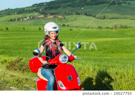 Young woman traveling by a scooter 20027793
