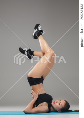 Beautiful sporty girl standing in acrobat pose or 20028488