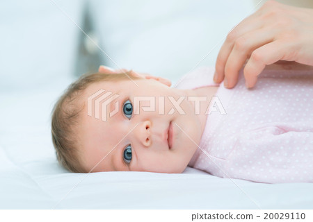 Nursing mother putting her little child in bed Nursing mother putting her little child in bed 20029110