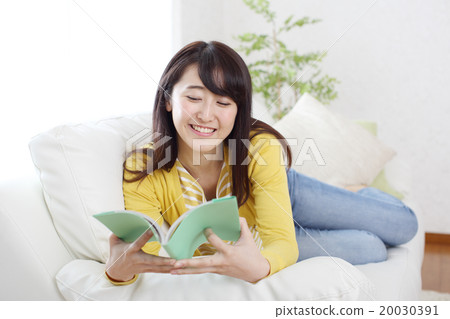 A woman reading a novel on a holiday A woman reading a novel on a holiday 20030391