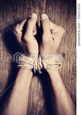 the hands of a young man tied with rope the hands of a young man tied with rope 20032058