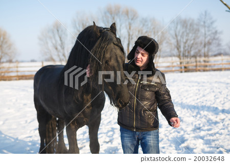 Man with frisian horse Man with frisian horse 20032648
