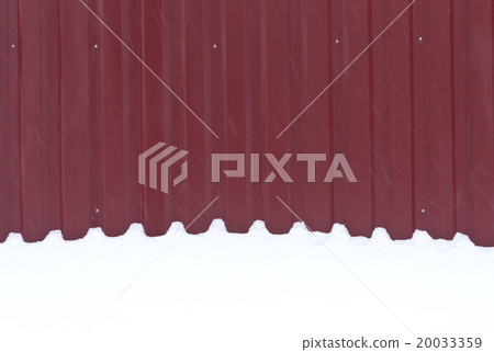 Red metal fence in snow. 20033359