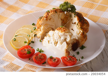 cut cauliflower baked close-up on a plate cut cauliflower baked close-up on a plate 20034054