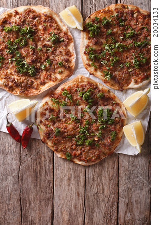 Asian pizza lahmacun on a table. vertical top view 20034133