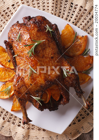 Roast duck with oranges close up on a plate Roast duck with oranges close up on a plate 20034774