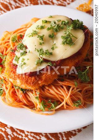 Chicken Parmigiana and pasta close-up on a plate Chicken Parmigiana and pasta close-up on a plate 20040997