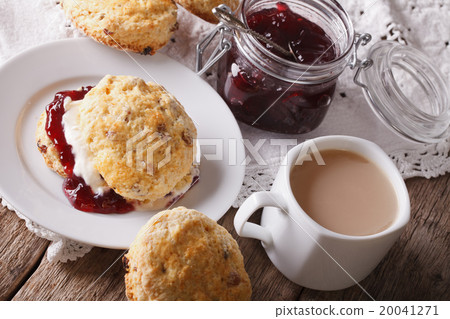Homemade scones with jam and tea with milk 20041271