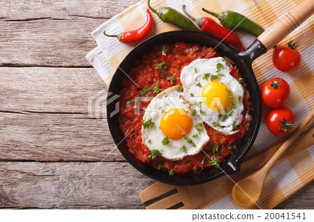 Mexican huevos rancheros close-up in a frying pan Mexican huevos rancheros close-up in a frying pan 20041541