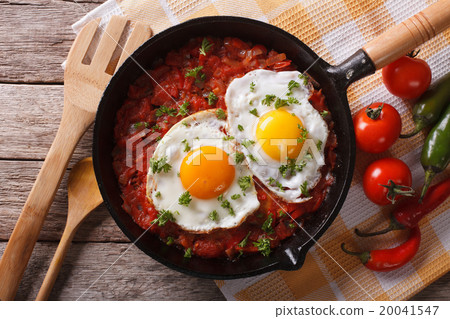 huevos rancheros closeup in the pan and ingredient 20041547