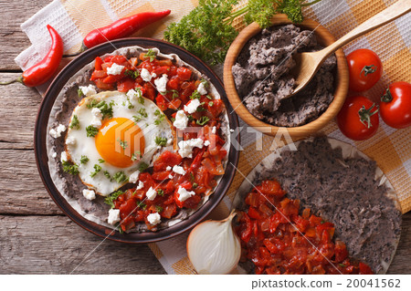 Mexican huevos rancheros on the plate closeup Mexican huevos rancheros on the plate closeup 20041562
