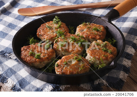 fishcakes with herbs close-up in a pan. Horizontal fishcakes with herbs close-up in a pan. Horizontal 20041706