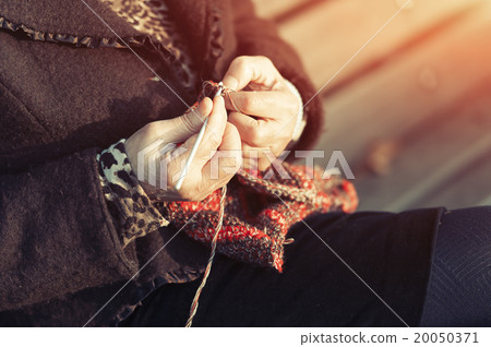 Hands of an elderly person crocheting 20050371