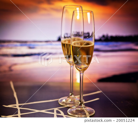 Champagne glasses on tropical beach  20051224
