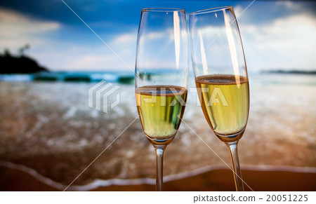 Champagne glasses on tropical beach  20051225