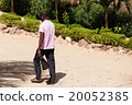 African man with pink polo shirt on dusty street 20052385