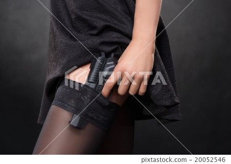 girl hand with a gun on a dark background in girl hand with a gun on a dark background in 20052546