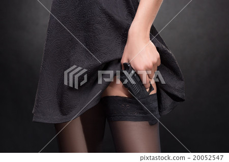 girl hand with a gun on a dark background in girl hand with a gun on a dark background in 20052547