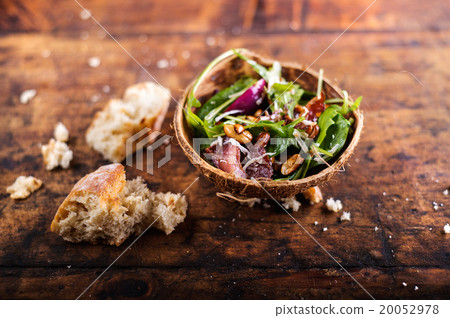 Rucola salad in coconut shell Rucola salad in coconut shell 20052978