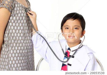 boy as doctor examining a girl 20053530