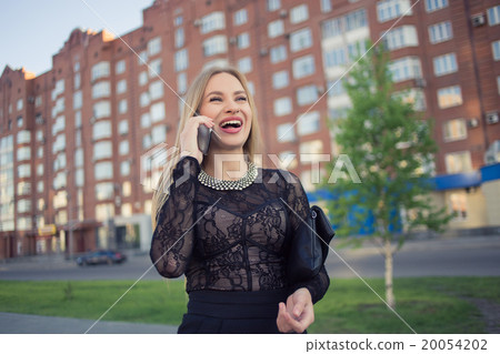 Business woman speaking cellphone on the street Business woman speaking cellphone on the street 20054202