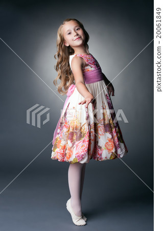 Smiling little dancer posing in studio 20061849