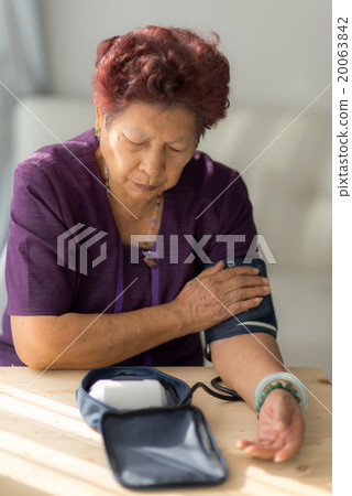 Asian senior woman checking blood pressure Asian senior woman checking blood pressure 20063842