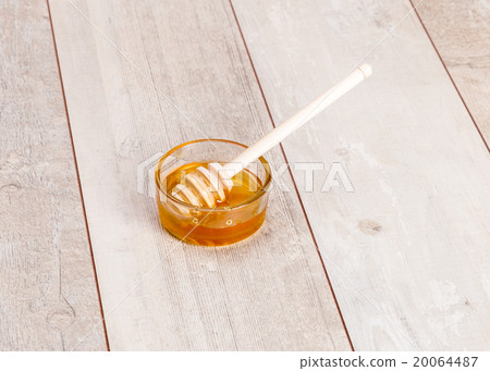 Fresh natural honey in jar with spoon Fresh natural honey in jar with spoon 20064487