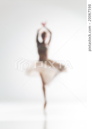 Blurred silhouette of ballerina on white 20067598