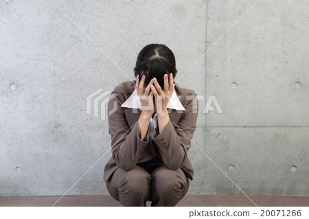 A woman who covers her face by hand 20071266
