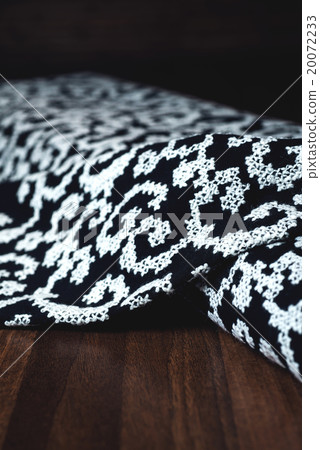 black textile with beautiful white ornament on black textile with beautiful white ornament on 20072233