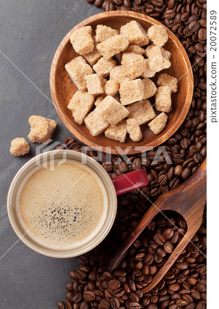 Coffee cup, beans and brown sugar on stone table 20072589