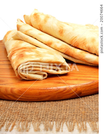 Lavash, tortilla wrap Bread on cutting board  20074664