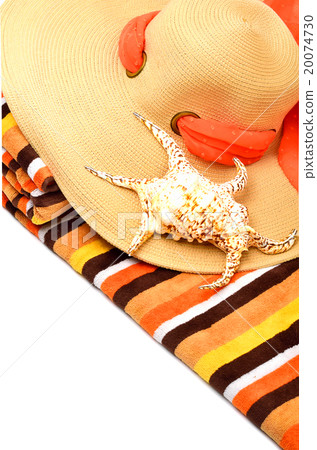 Woman beach hat, bright towel and a seashell 20074730