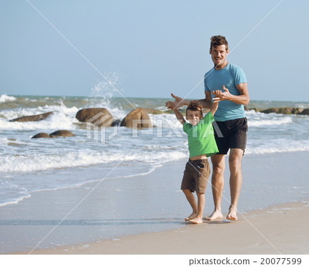 happy family on beach playing, father with son happy family on beach playing, father with son 20077599