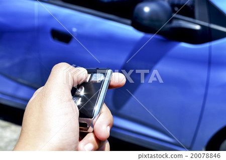 hand holding a car's remote control 20078846