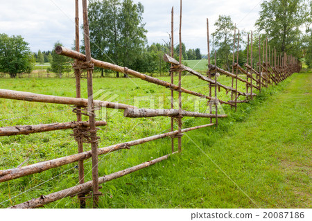 Old traditional wooden fence and meadow 20087186