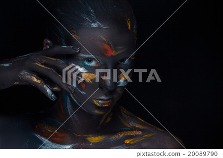 Portrait of a young woman who is posing covered 20089790