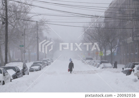 Man walk along snow covered street 20092016